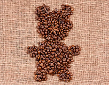 Bear made of coffee beans on the old burlapの写真素材