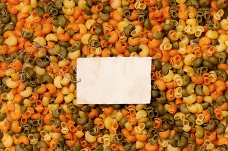 Old empty paper on raw pasta, can be used as backgroundの写真素材