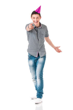 Young man in shirt with birthday cap, isolated on white backgroundの写真素材