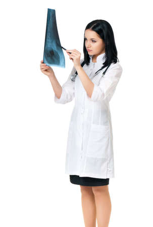 Female doctor examining an x-ray picture on white backgroundの写真素材