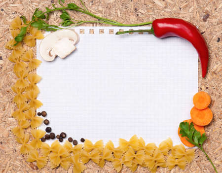 Paper for recipes with pasta, vegetables, and spices on wooden tableの写真素材