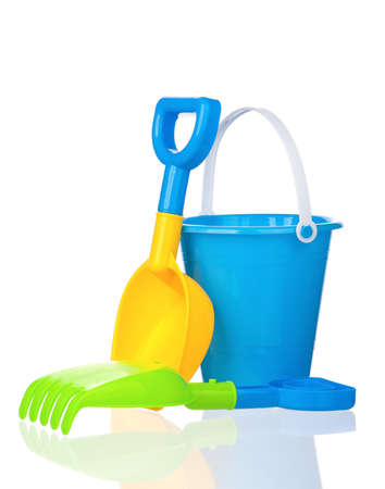 Toy bucket, rake and spade isolated on white backgroundの写真素材