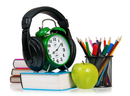 Time concept - alarm clock with books, headphones, pencils and appleの写真素材