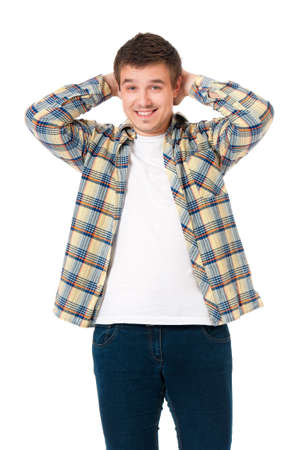 Young man looking at camera while holding his head, isolated on white backgroundの写真素材