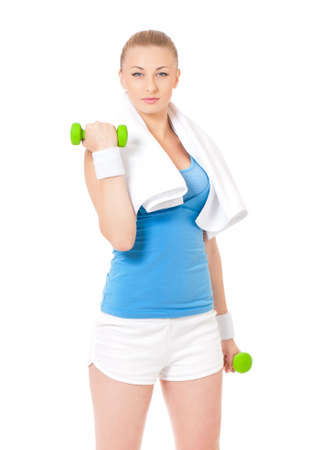 Happy young woman in fitness wear exercising with dumbbells and towel, isolated on white backgroundの写真素材
