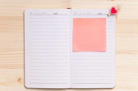 Open notebook on wood background - top viewの写真素材