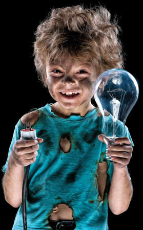 Portrait of funny little electrician with lightbulb over black backgroundの写真素材
