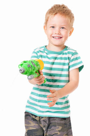 Happy boy with plastic water gun isolated on white backgroundの写真素材