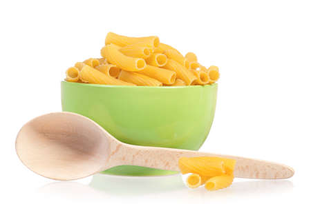 Pasta in green plate with wooden spoon, isolated on white backgroundの写真素材