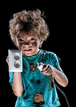 Portrait of funny little electrician over black backgroundの写真素材