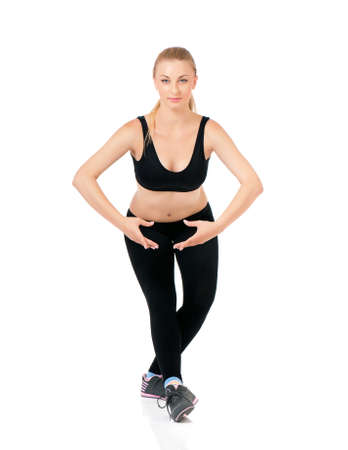 Young happy woman doing fitness exercise, isolated on white backgroundの写真素材