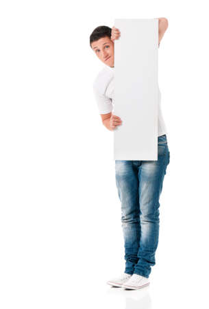 Handsome young man portrait with empty white board isolated on white backgroundの写真素材