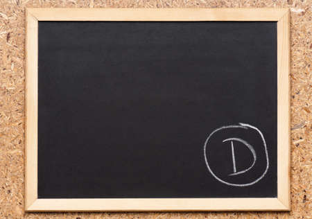 Letter D written on chalkboard, getting bad gradesの写真素材