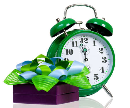 Gift box with green alarm clock, isolated on white backgroundの写真素材