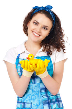 Young housewife with yellow gloves and yellow rubber duck, isolated on white backgroundの写真素材