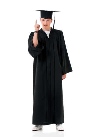 Young graduation man showing something, isolated on white backgroundの写真素材