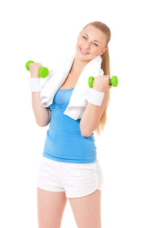 Happy young woman in fitness wear exercising with dumbbells, isolated on white backgroundの写真素材