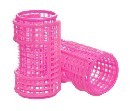 Few pink hair curlers, isolated on white backgroundの写真素材