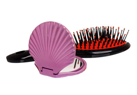 Pocket makeup mini mirror and small black hairbrush isolated on white backgroundの写真素材