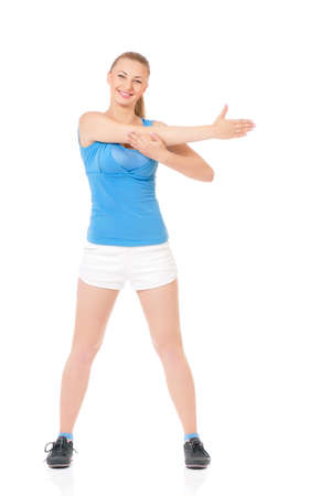 Young happy woman doing fitness exercise, isolated on white backgroundの写真素材
