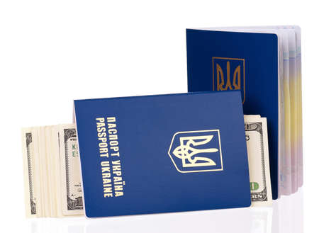 International Ukrainian passport with US dollars banknotes, isolated on white backgroundの写真素材