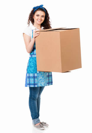 Young housewife with big cardboard box, isolated on white backgroundの写真素材