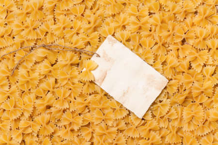 Old empty paper on raw pasta, can be used as backgroundの写真素材