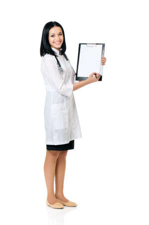Portrait of smiling female doctor holding a clipboard - isolated over a white backgroundの写真素材