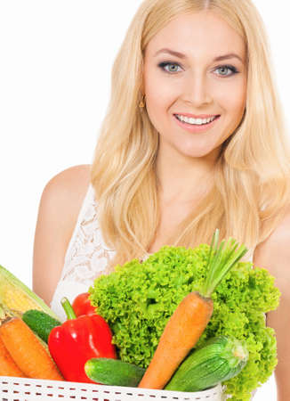 Happy beautiful woman with fresh vegetables, isolated on white backgroundの写真素材