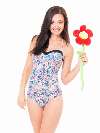 Beautiful young woman in swimsuit with big flower, isolated over white backgroundの写真素材