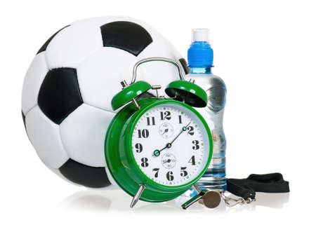 Big green alarm clock with soccer ball, metal whistle and bottle of water, isolated on white backgroundの写真素材