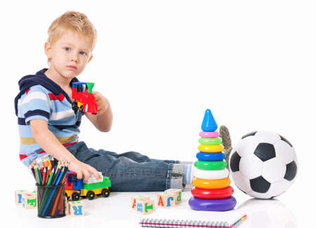 Little boy with toys isolated on white backgroundの写真素材