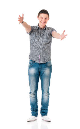 Full length portrait of smiling young man greets with his hands, isolated on white backgroundの写真素材