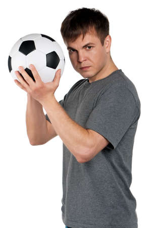Portrait of a man standing with classic soccer ball on isolated white backgroundの写真素材