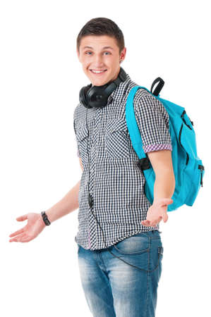 Full length portrait of a caucasian guy student of college or university with backpack. Young casual male presenting something on his face against white background.の写真素材