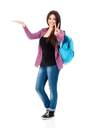 Happy teenage student girl holding her hand showing on open palm with empty copy space, isolated over white backgroundの写真素材