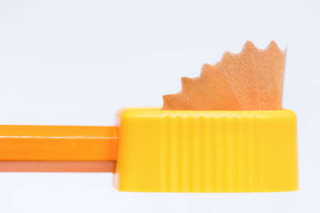 Close up of yellow sharpener with pencil on white backgroundの写真素材