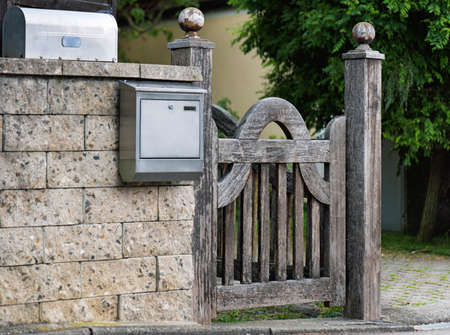 Old rustic wooden gate on stone wall. Countryside scene.の写真素材