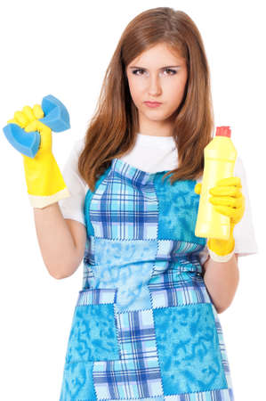 Young woman holding bottle of chemistry for cleaning house. Cleaning concept. Beautiful girl with cleaning tools and products on white background. Housekeeper isolated portrait.の写真素材