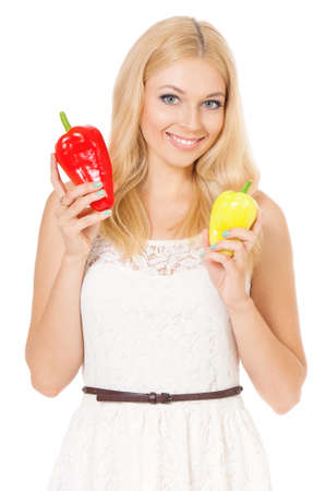 Half-length portrait of very beautiful woman holding fresh bell peppers. Smiling young housewife with red and yellow paprika. Studio shot isolated on white background. Healthy eating concept.の写真素材