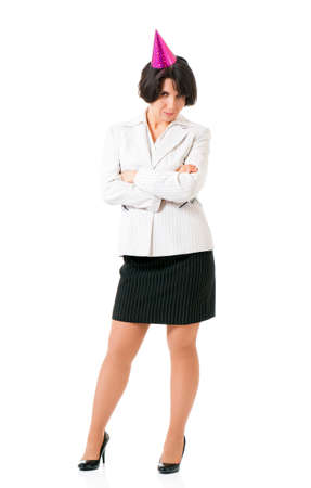 Full length portrait of a young businesswoman in birthday cap, isolated white background. Hen party or birthday celebration. Woman with party hats posing with  folded arms.の写真素材