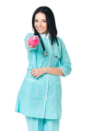 Young doctor holding pink enema. Portrait of beautiful young scientific researcher or woman doctor, isolated on white background.の写真素材