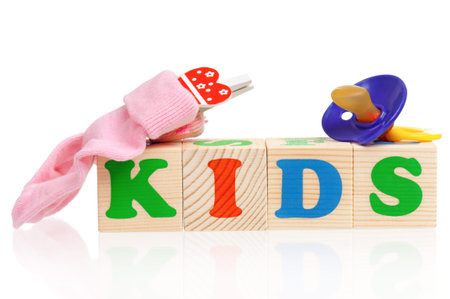 Kids word formed by colorful wooden alphabet blocks, isolated on white background