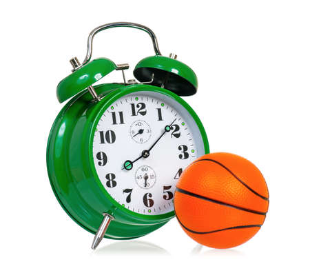 Sport concept - big green alarm clock with small ball for basketball, isolated on white backgroundの写真素材
