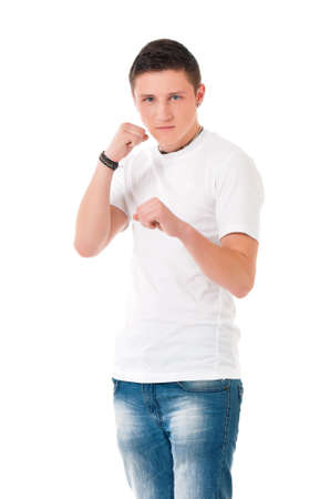 Portrait of angry young man holding fists, isolated on white backgroundの写真素材