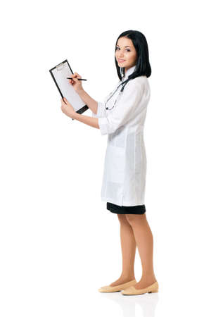 Portrait of smiling female doctor holding a clipboard - isolated over a white backgroundの写真素材
