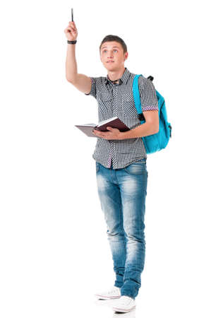 Full length portrait of a caucasian guy student of college or university with backpack and notepad. Casual young male - teen boy - isolated white background.の写真素材