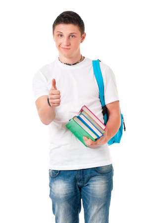 Portrait of a caucasian guy student of college or university with books. Casual young male isolated white background. Teen boy making thumb up gesture and looking at camera.の写真素材