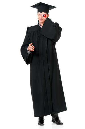 Portrait of man in an academic gown holding a diploma - graduate guy student, isolated on white background の写真素材