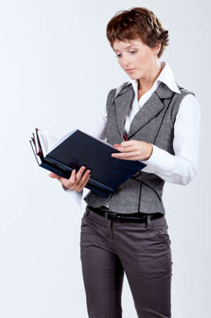 Portrait of a beautiful caucasian businesswoman or teacher with booksの写真素材